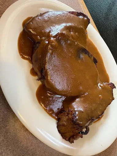 Sliced roast beef smothered in brown gravy